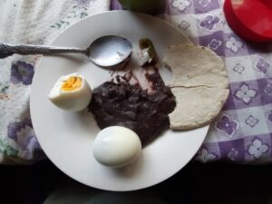 Desayuno typico - a classical guatemalan breakfast: eggs, beans, tortillas and atoll
